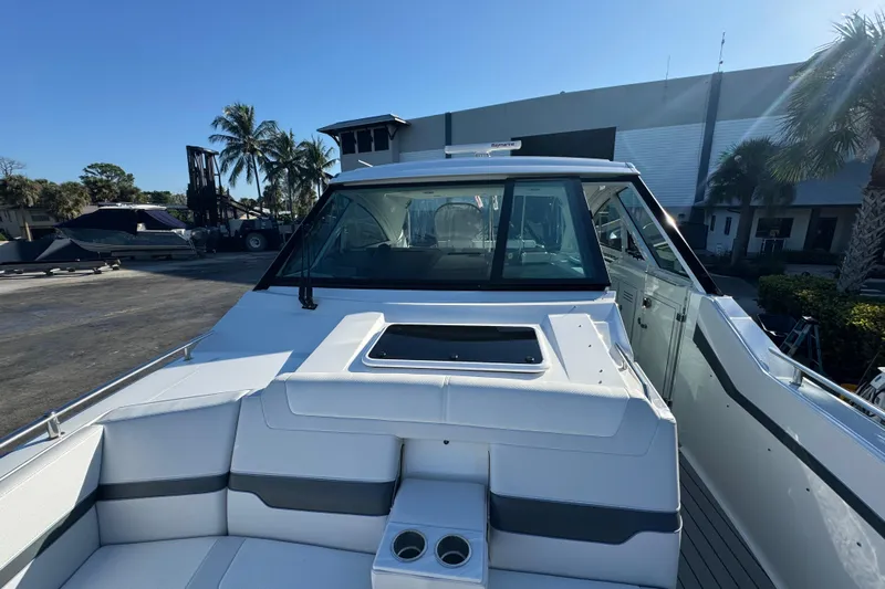 Millennium Falcon Yacht Photos Pics 2023 Formula 400 Super Sport Crossover boat, docked with palm trees in the background.