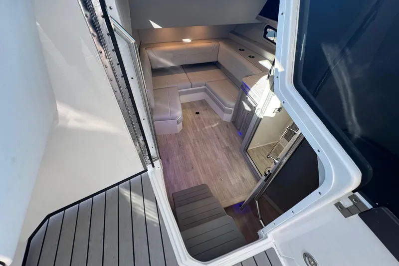 Millennium Falcon Yacht Photos Pics Interior view of 2023 Formula 400 Super Sport Crossover, featuring modern seating and wood flooring.