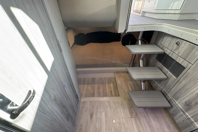 Millennium Falcon Yacht Photos Pics 2023 Formula 400 Super Sport Crossover cabin interior with modern wood finish and compact stairs.