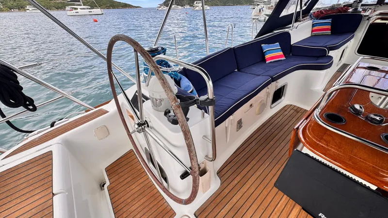 Cadence Yacht Photos Pics Luxurious Jeanneau Sun Odyssey 54 DS yacht cockpit with wooden deck and comfortable seating, 2008 model.