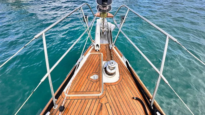 Cadence Yacht Photos Pics Bow of 2008 Jeanneau Sun Odyssey 54 DS yacht with teak deck and stainless steel railings.