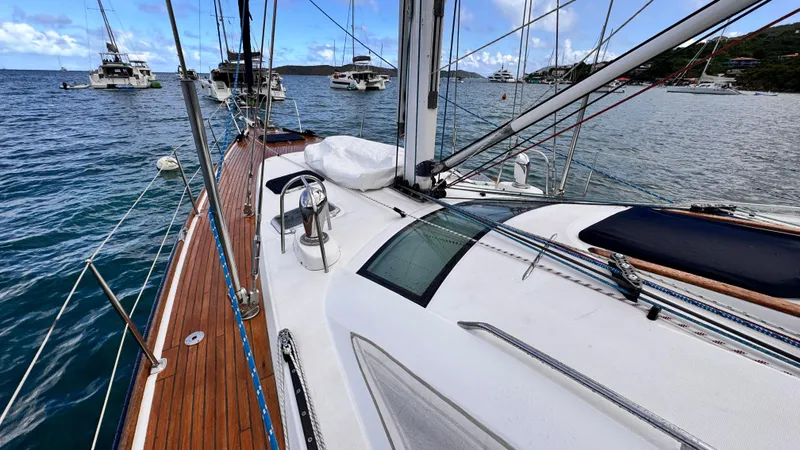 Cadence Yacht Photos Pics 2008 Jeanneau Sun Odyssey 54 DS sailboat with teak deck, anchored in a scenic marina.