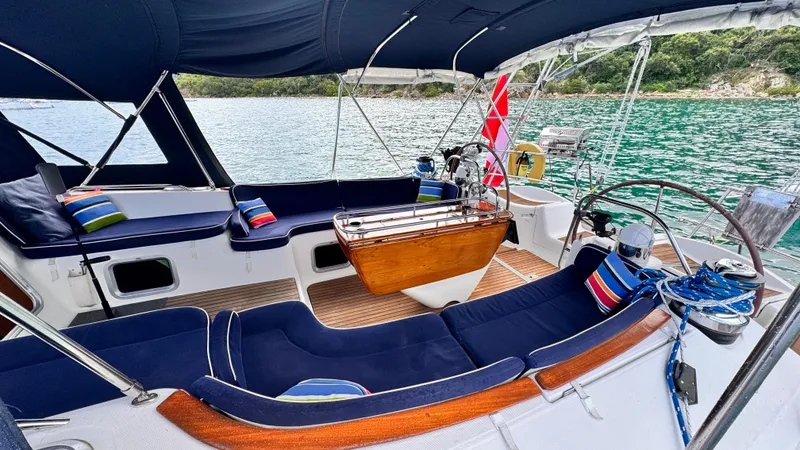 Cadence Yacht Photos Pics Luxurious 2008 Jeanneau Sun Odyssey 54 DS yacht cockpit with navy seating and scenic water view.