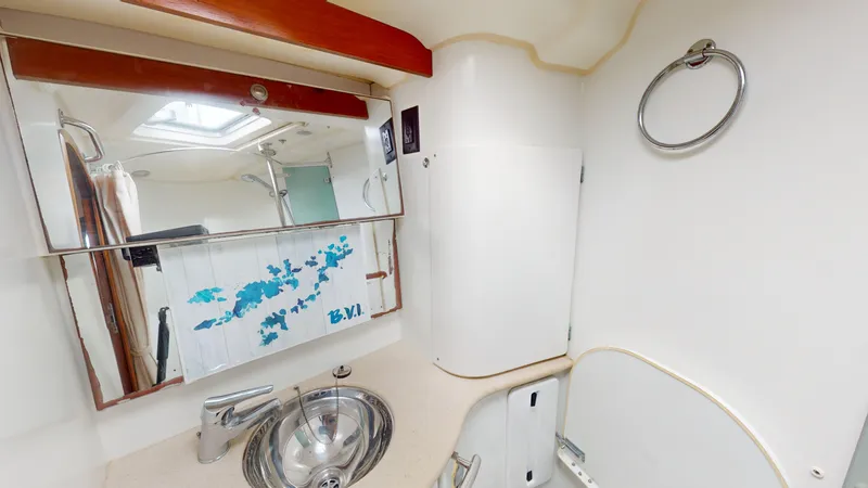 Cadence Yacht Photos Pics Bathroom interior of 2008 Jeanneau Sun Odyssey 54 DS yacht, featuring sink and mirror.