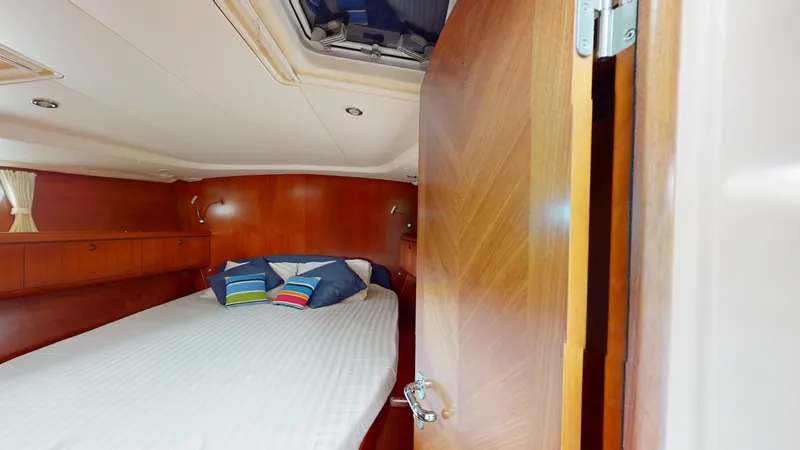 Cadence Yacht Photos Pics Cozy cabin interior of 2008 Jeanneau Sun Odyssey 54 DS yacht with bed and pillows.