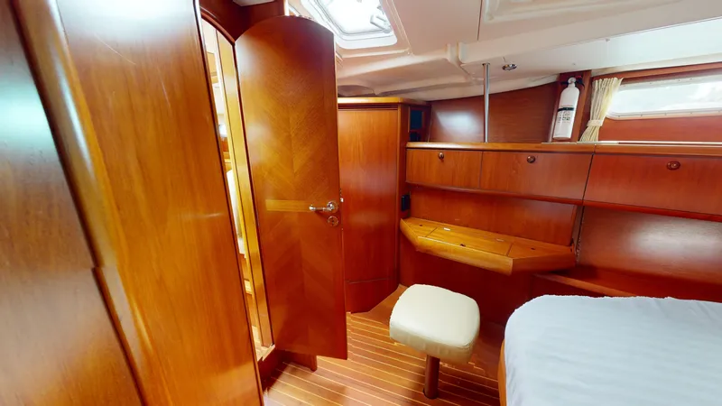 Cadence Yacht Photos Pics Luxurious cabin interior of 2008 Jeanneau Sun Odyssey 54 DS yacht, featuring elegant wood finish.