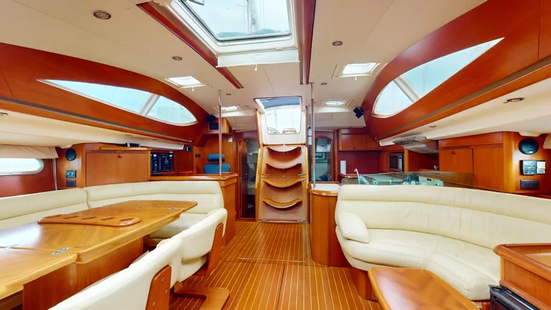 Cadence Yacht Photos Pics Luxurious interior of 2008 Jeanneau Sun Odyssey 54 DS yacht with elegant wood finish.