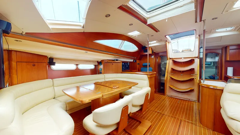 Cadence Yacht Photos Pics Luxurious interior of 2008 Jeanneau Sun Odyssey 54 DS yacht with elegant wood finish.