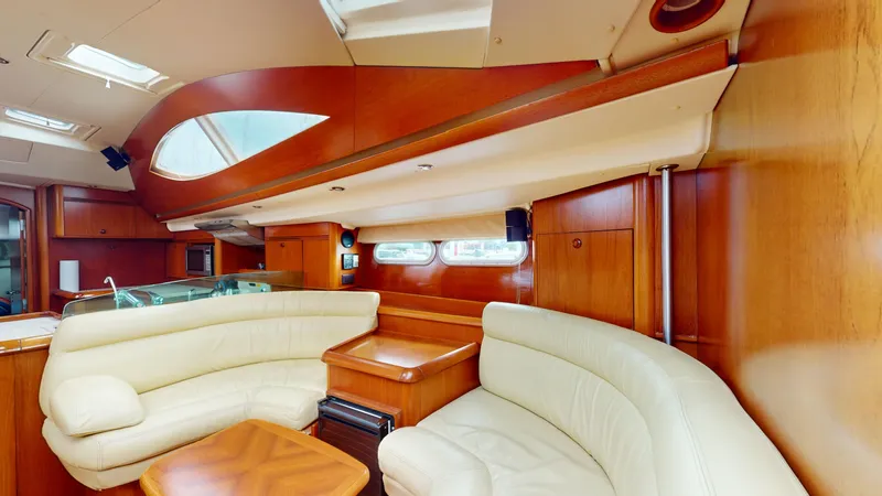 Cadence Yacht Photos Pics Luxurious interior of 2008 Jeanneau Sun Odyssey 54 DS yacht with elegant wood finish.