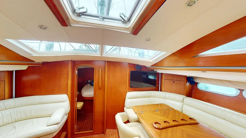 Cadence Yacht Photos Pics Interior of 2008 Jeanneau Sun Odyssey 54 DS yacht with elegant wood and white seating.