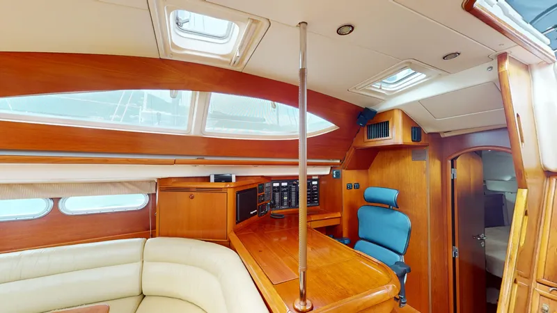 Cadence Yacht Photos Pics Interior of 2008 Jeanneau Sun Odyssey 54 DS yacht with wood finish and seating area.