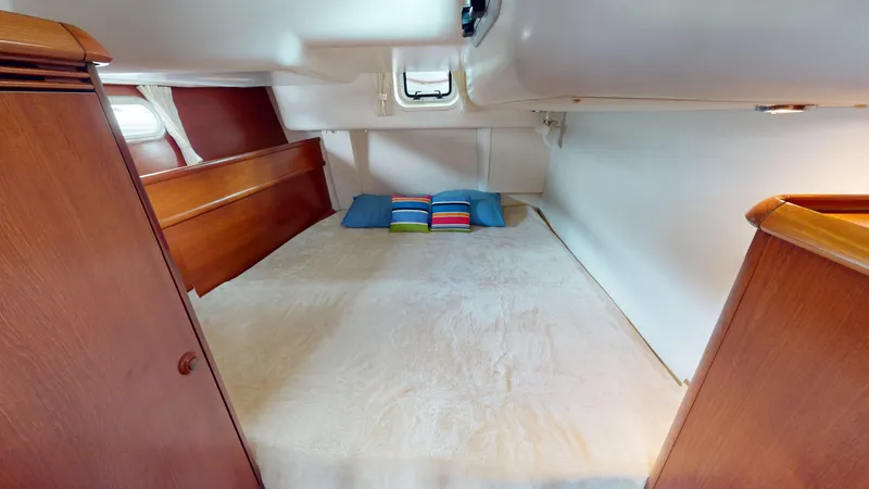 Cadence Yacht Photos Pics 2008 Jeanneau Sun Odyssey 54 DS cabin with cozy bed and colorful pillows.