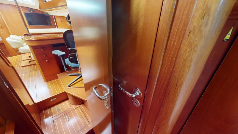 Cadence Yacht Photos Pics Interior of 2008 Jeanneau Sun Odyssey 54 DS yacht, featuring wooden finishes and seating area.