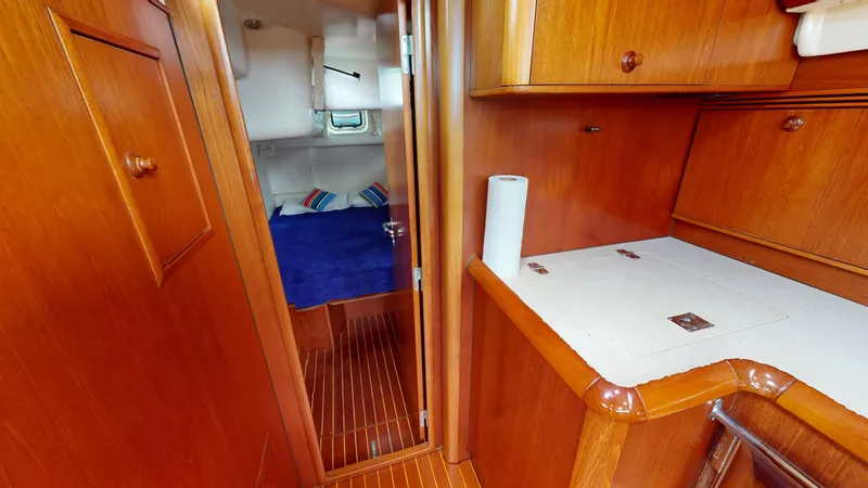 Cadence Yacht Photos Pics Interior of 2008 Jeanneau Sun Odyssey 54 DS yacht, featuring wooden cabinetry and cozy cabin.