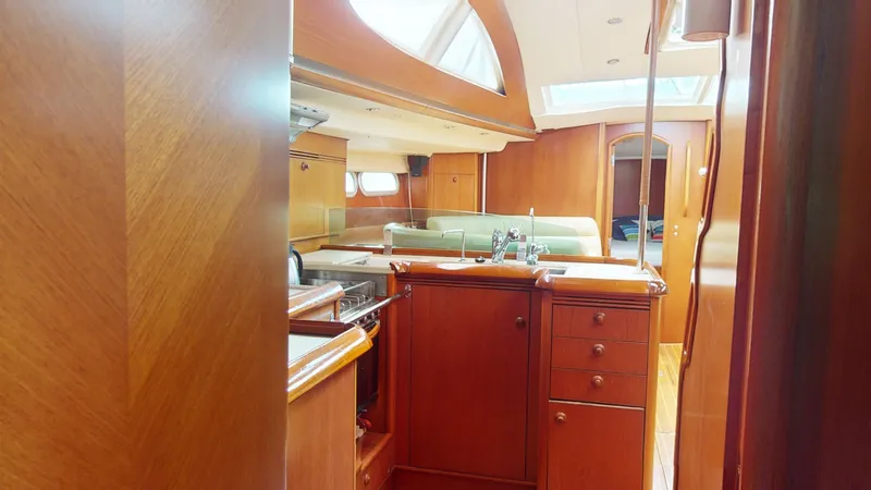 Cadence Yacht Photos Pics Interior of 2008 Jeanneau Sun Odyssey 54 DS yacht with wooden cabinetry and skylights.