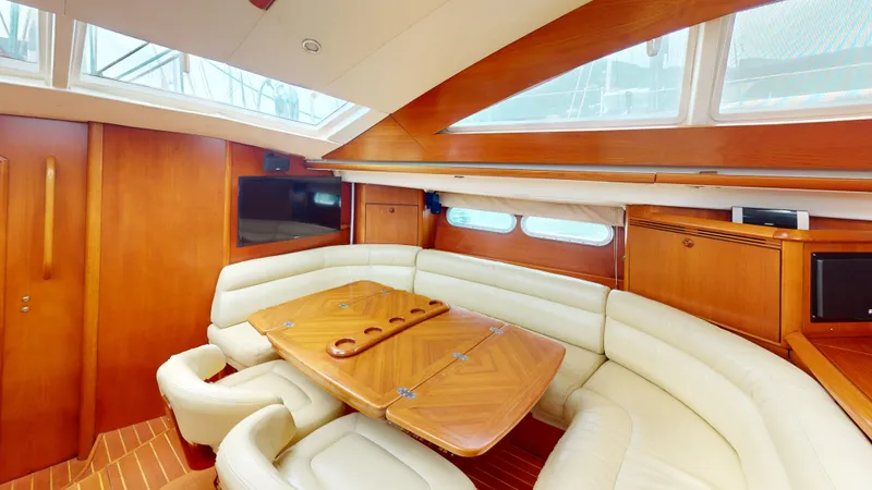 Cadence Yacht Photos Pics Luxurious interior of 2008 Jeanneau Sun Odyssey 54 DS yacht with elegant seating and wooden finishes.