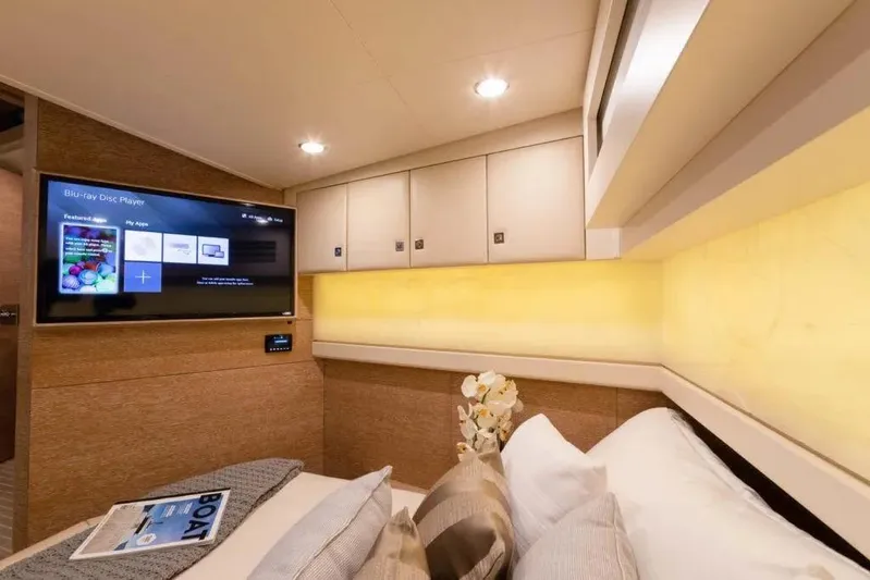 You Only Live Twice Yacht Photos Pics Luxurious cabin interior of 2020 Scout 530 LXF yacht with TV and cozy bedding.