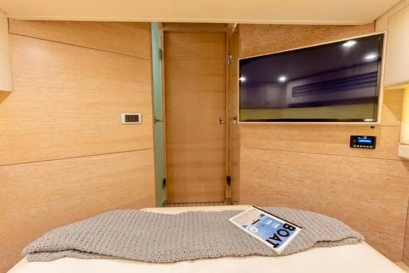 You Only Live Twice Yacht Photos Pics Luxurious interior of 2020 Scout 530 LXF yacht with TV and cozy bedding.