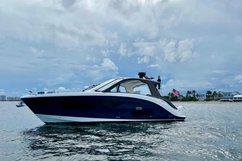  Yacht Photos Pics 2022 Sea Ray Sundancer 370 Outboard cruising on calm waters under a cloudy sky.