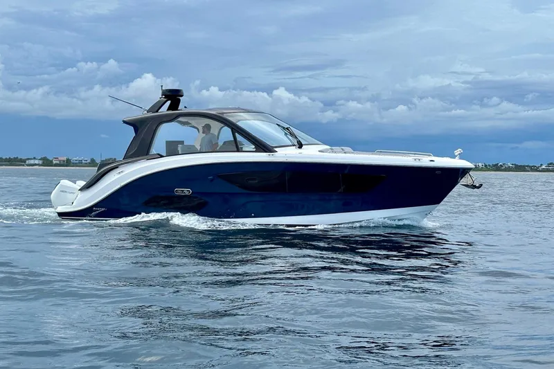  Yacht Photos Pics 2022 Sea Ray Sundancer 370 Outboard cruising on calm waters under a cloudy sky.