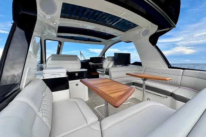  Yacht Photos Pics Luxurious interior of 2022 Sea Ray Sundancer 370 Outboard with elegant seating and wooden tables.