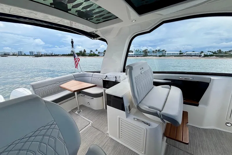  Yacht Photos Pics 2022 Sea Ray Sundancer 370 Outboard interior with seating, table, and scenic water view.