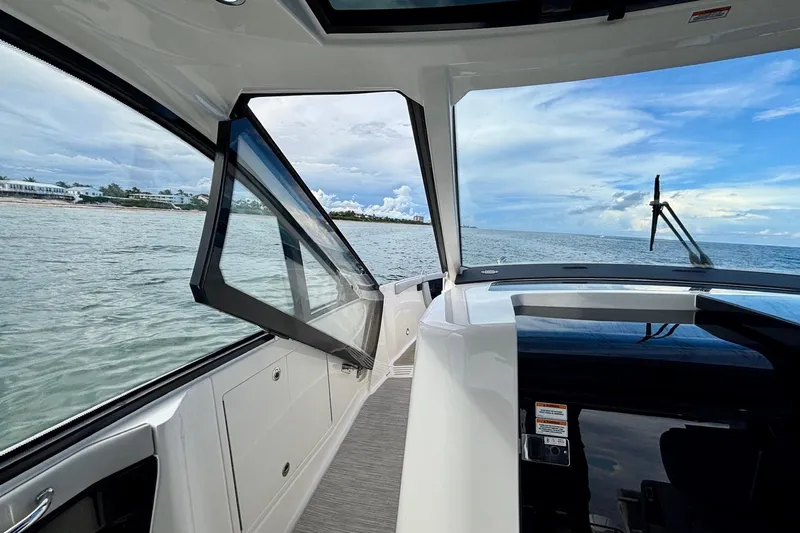  Yacht Photos Pics 2022 Sea Ray Sundancer 370 Outboard interior with open window, ocean view, and sleek design.