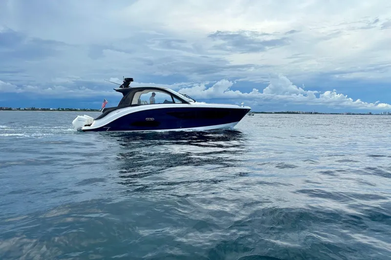  Yacht Photos Pics 2022 Sea Ray Sundancer 370 Outboard cruising on open water under a cloudy sky.