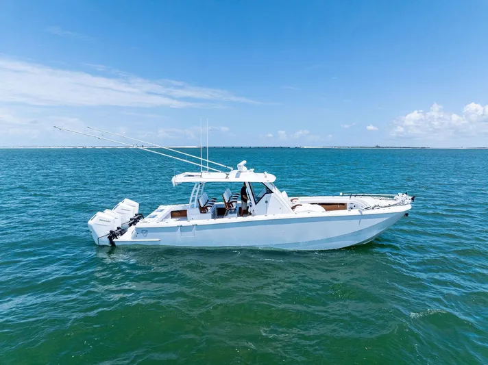 Down Range Yacht Photos Pics 2023 Barker Boatworks 40 HPC cruising on open water under clear blue skies.