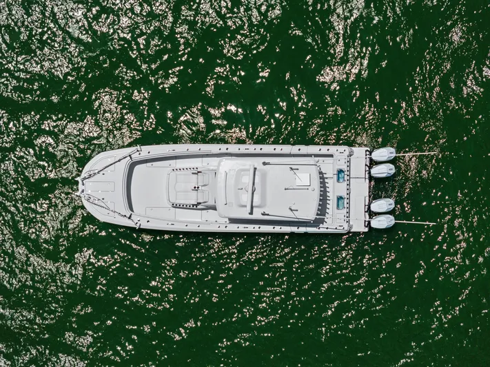 Down Range Yacht Photos Pics Aerial view of 2023 Barker Boatworks 40 HPC on shimmering green water.