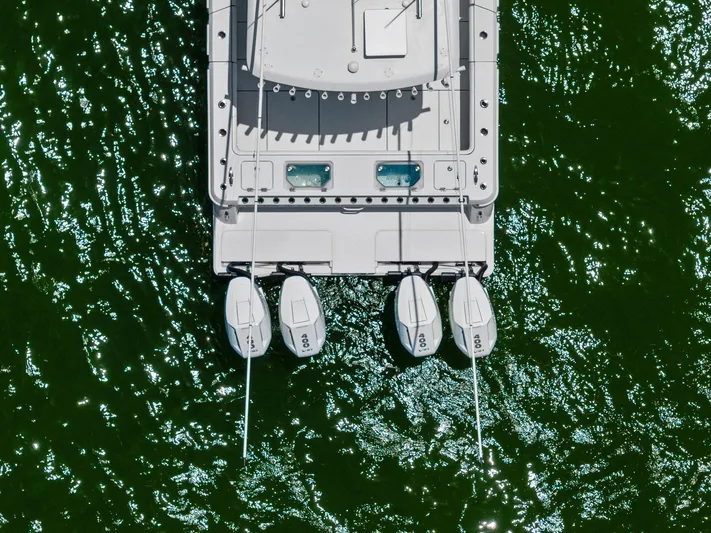 Down Range Yacht Photos Pics Aerial view of 2023 Barker Boatworks 40 HPC with four engines on green water.