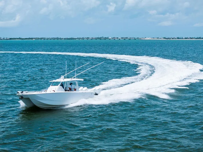 Down Range Yacht Photos Pics 2023 Barker Boatworks 40 HPC cruising on open water, leaving a wake trail.