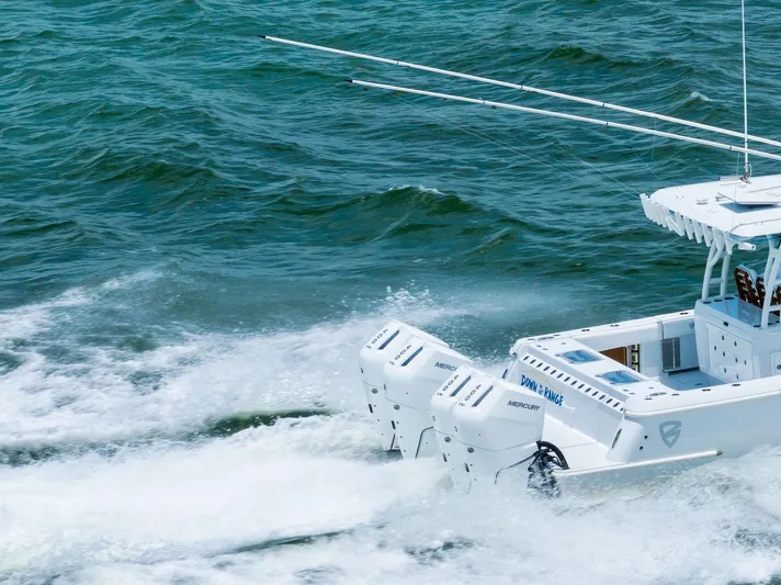 Down Range Yacht Photos Pics 2023 Barker Boatworks 40 HPC cruising on open water, showcasing powerful engines.