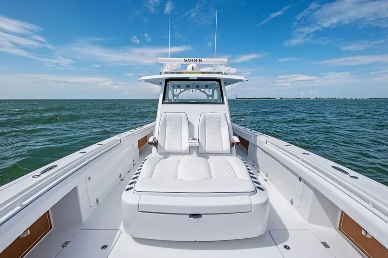 Down Range Yacht Photos Pics 2023 Barker Boatworks 40 HPC on open water, featuring luxurious seating and clear skies.