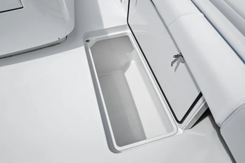 Down Range Yacht Photos Pics Storage compartment on 2023 Barker Boatworks 40 HPC, featuring sleek white interior design.