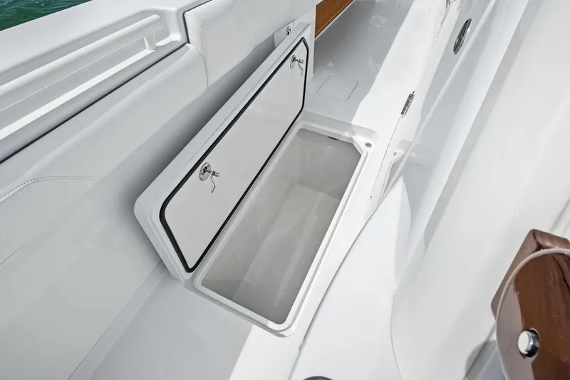 Down Range Yacht Photos Pics 2023 Barker Boatworks 40 HPC storage compartment with open hatch, showcasing sleek design.