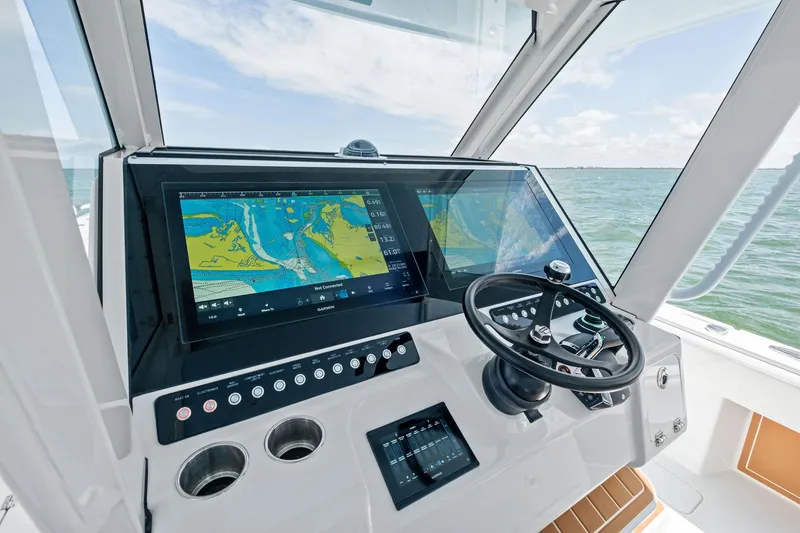 Down Range Yacht Photos Pics 2023 Barker Boatworks 40 HPC helm with advanced navigation system and steering wheel.