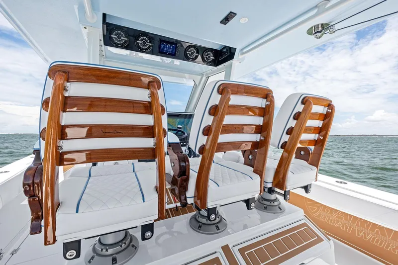 Down Range Yacht Photos Pics Luxury seating on 2023 Barker Boatworks 40 HPC, featuring elegant wood and white upholstery.