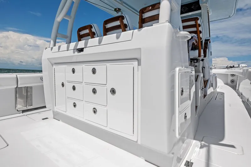 Down Range Yacht Photos Pics 2023 Barker Boatworks 40 HPC interior with storage compartments and seating, under a clear blue sky.