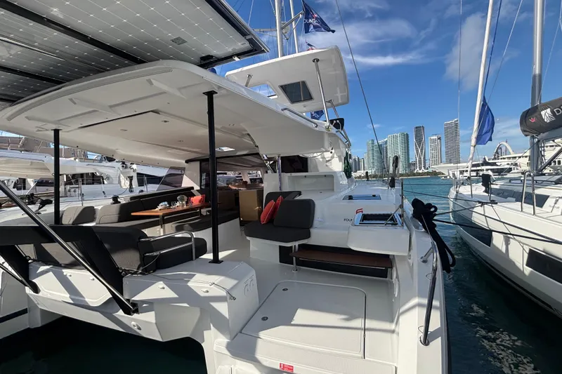 The Ilusion Yacht Photos Pics 2025 Fountaine Pajot 41 catamaran docked, featuring spacious deck and modern design.