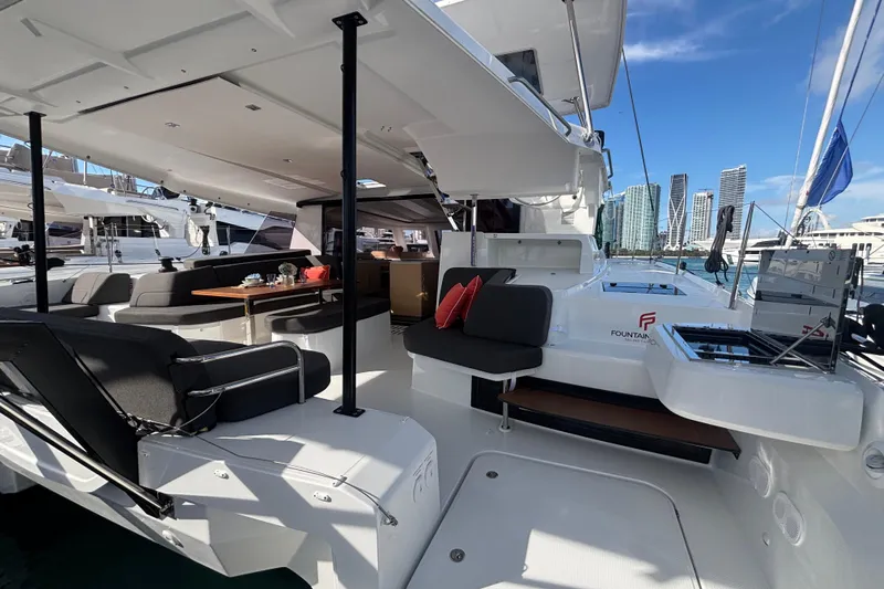 The Ilusion Yacht Photos Pics Luxurious 2025 Fountaine Pajot 41 catamaran interior with modern seating and dining area.