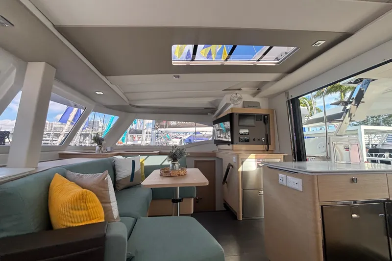 The Ilusion Yacht Photos Pics Luxurious interior of 2025 Fountaine Pajot 41 catamaran with modern furnishings and panoramic windows.