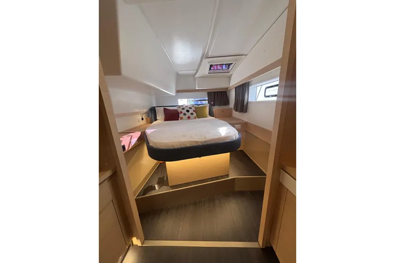 The Ilusion Yacht Photos Pics Luxurious cabin interior of 2025 Fountaine Pajot 41 yacht, featuring a cozy bed and modern design.