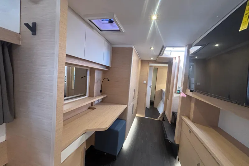 The Ilusion Yacht Photos Pics Modern interior of 2025 Fountaine Pajot 41 yacht with sleek wood finishes and ample lighting.