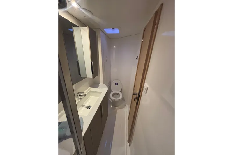 The Ilusion Yacht Photos Pics Modern bathroom interior on 2025 Fountaine Pajot 41 yacht, featuring sleek design and fixtures.