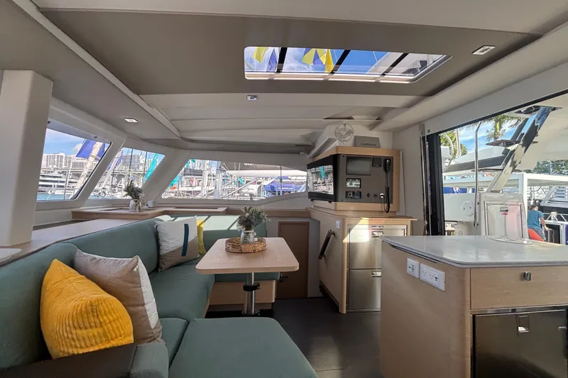 The Ilusion Yacht Photos Pics Luxurious interior of 2025 Fountaine Pajot 41 catamaran with modern furnishings and large windows.