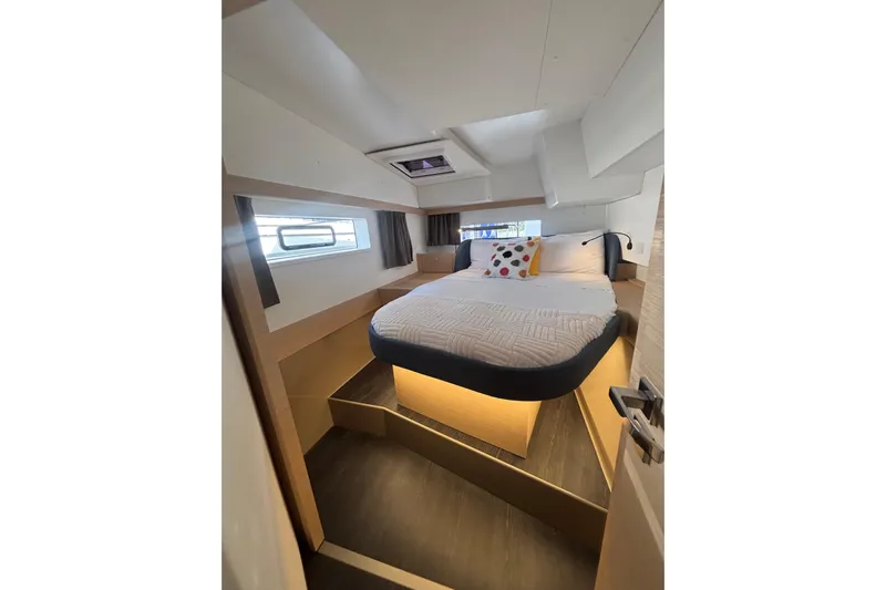 The Ilusion Yacht Photos Pics Luxurious cabin interior of 2025 Fountaine Pajot 41 yacht, featuring a cozy bed and modern design.