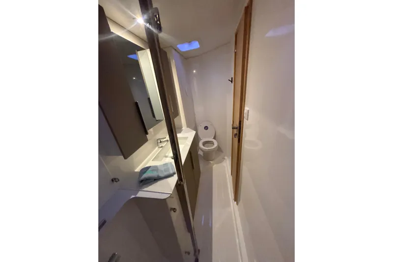 The Ilusion Yacht Photos Pics Bathroom interior of 2025 Fountaine Pajot 41 yacht, featuring modern fixtures and sleek design.