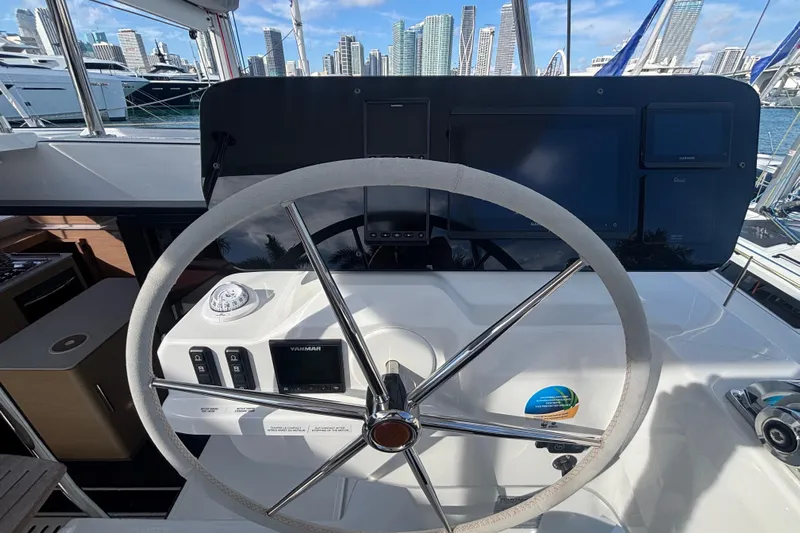 The Ilusion Yacht Photos Pics Helm of 2025 Fountaine Pajot 41 catamaran with city skyline in background.