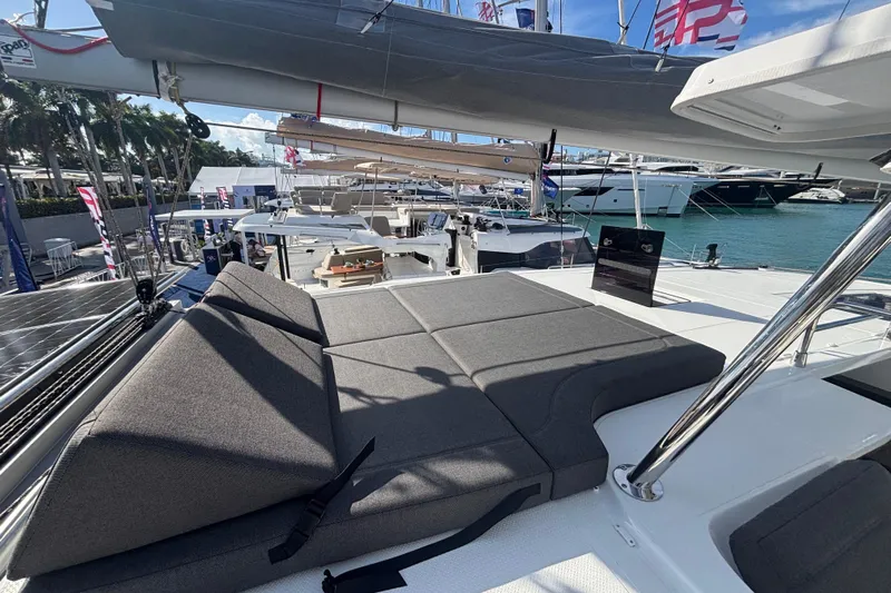 The Ilusion Yacht Photos Pics 2025 Fountaine Pajot 41 catamaran with sunbathing area, docked at marina.